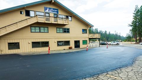 Snow Valley parking lot being repaved, another angle of the Snow Valley main lodge building in the background