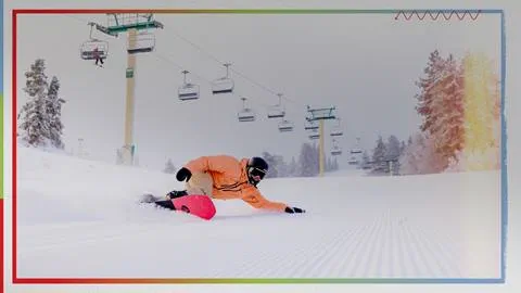snowboarder going down a ski slope in the winter