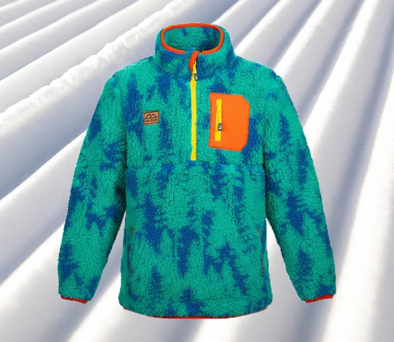 The front of a green and blue tree design soft fleece jacket with orange front check pocket, yellow quarter zipper, and leather patch.
