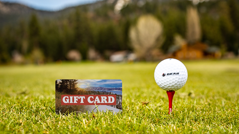BBMR Gift Card in the grass next to a bear mountain golf course gold ball on a tee
