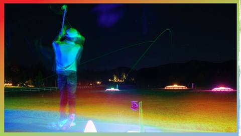 A golfer at the glow in the dark driving range at Bear Mountain Golf Course hitting balls to glow in the dark targets.