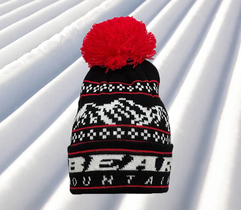 Black Beanie with white bear mountain stitching for the logo and red accent stitching with red pom pom at top