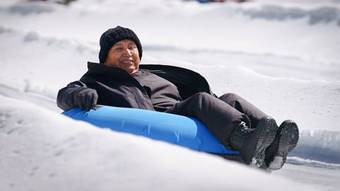Adult in a snow tube at Snow Valley