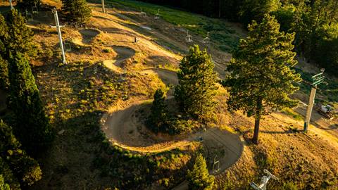 A drone image at sunset of a snake run dirt biking trail at Summit Bike Park.