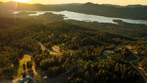 Summer sunset drone view of Big Bear Lake and the top of Chair 1 at Snow Summit.