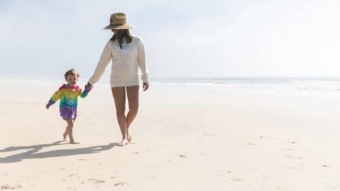 Mom and daughter on the beach in Snow Summit apparel