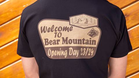 Black shirt with a brown and tan logo that says welcome to bear mountain, opening day 23/24