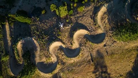Summertime bike park done image of a mountain bike trail with berms at Snow Summit.
