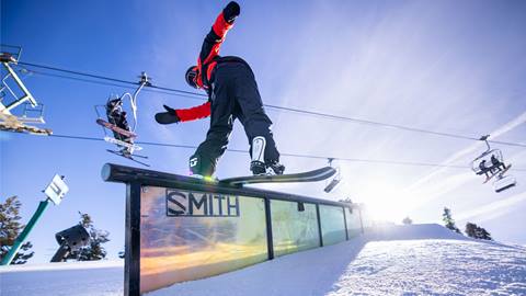 snowboarder doing a trick on a smith rail