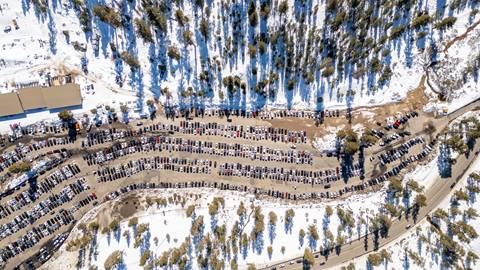 A drone shot of the Snow Valley parking lot full of cars on a busy winter day